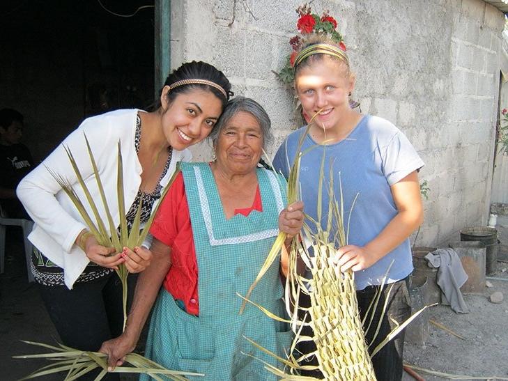 students in mexico create palm art with host family